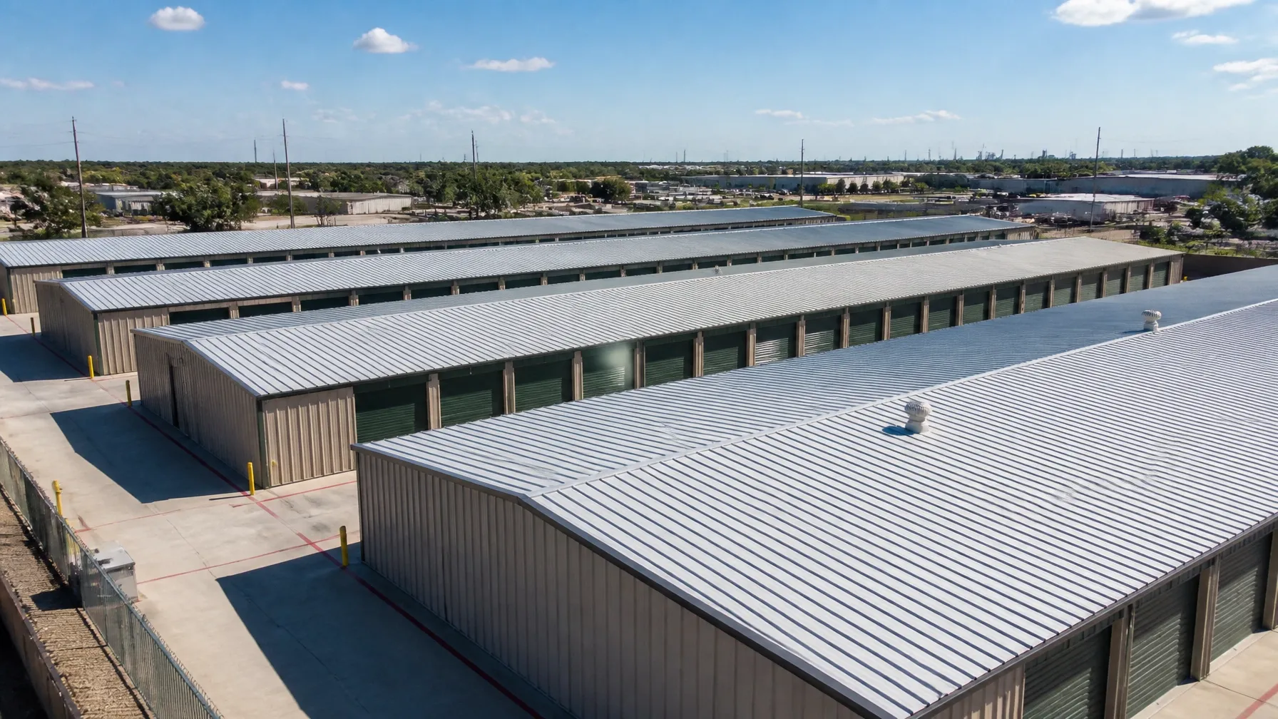 Rows of low-slope metal self-storage buildings under the bright Texas sun